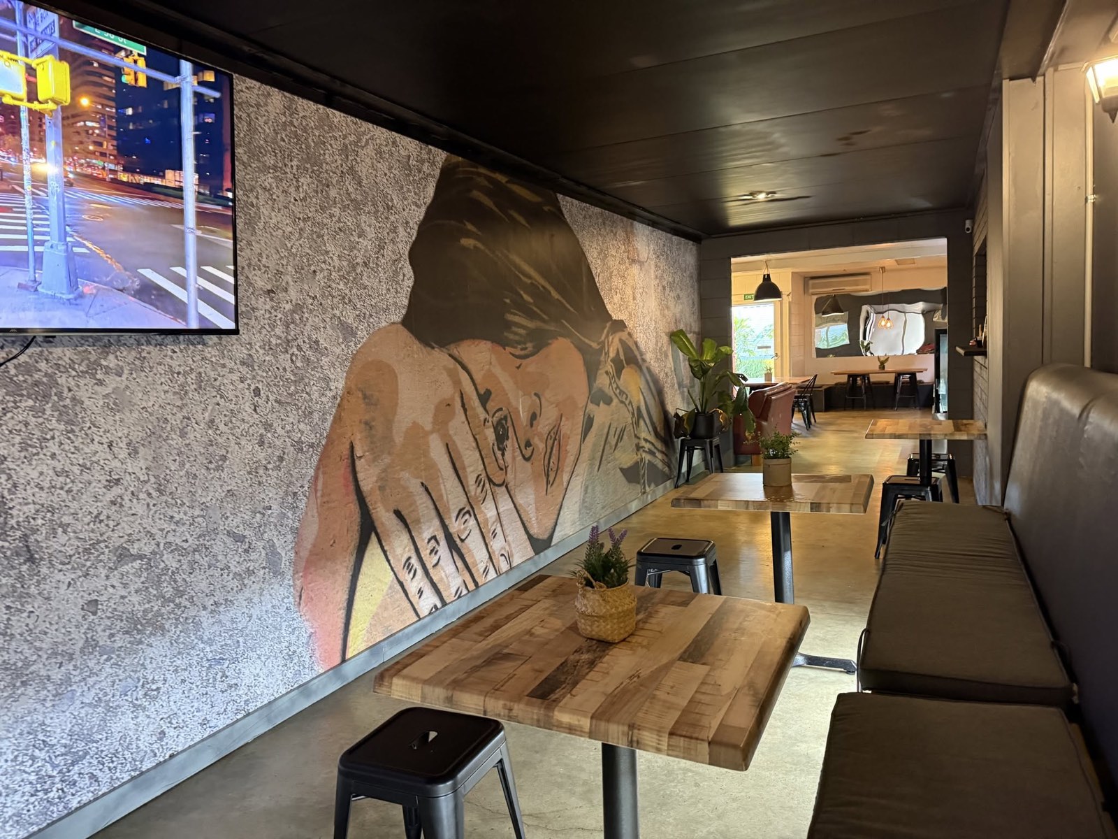 Inside RedDoor Café in Cloncurry — timber tables and the mural wall